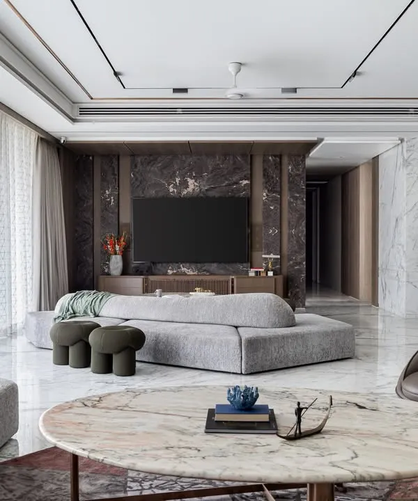 This expansive living area showcases our signature style of understated luxury. We used polished marble flooring and a mix of custom modular and statement seating to create distinct zones for conversation and relaxation, all unified by a sophisticated, neutral palette.