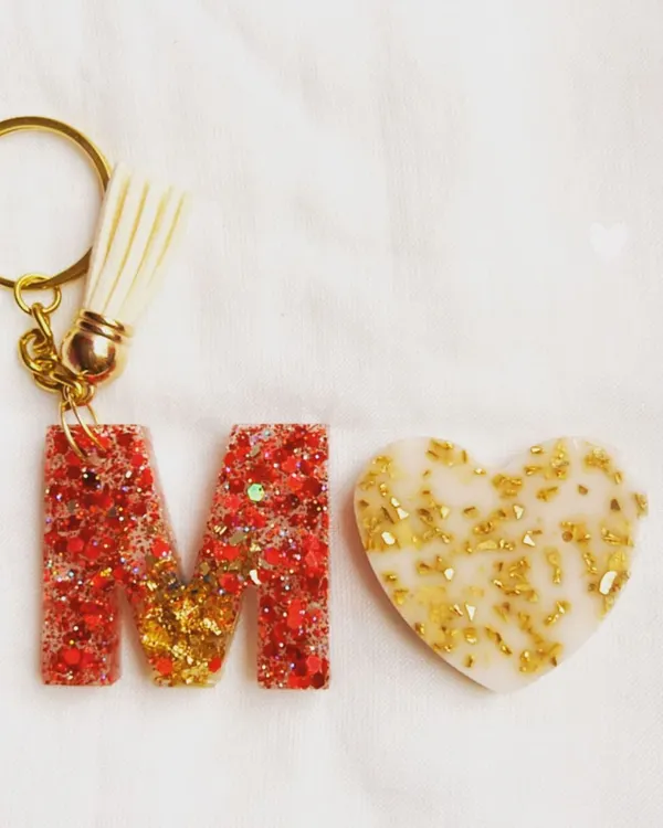 My initial keychains are one of my most requested items. This 'M' keychain is made with red glitter and gold leaf, paired with a matching heart charm.