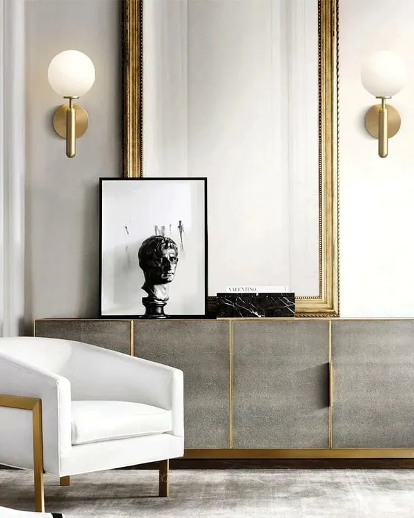 A perfect example of functional elegance, these modern globe sconces with a frosted finish provide soft, diffused light. Placed on either side of a mirror, they create a balanced and inviting vanity or entryway setting.