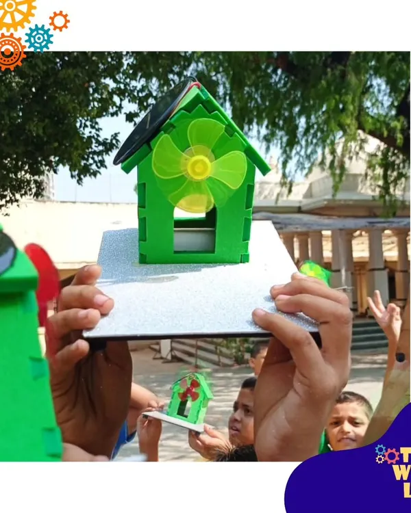 Harnessing the power of the sun! Students at New Activity School in Mumbai hold up the solar-powered fan houses they built. This was a perfect outdoor session to learn about renewable energy.