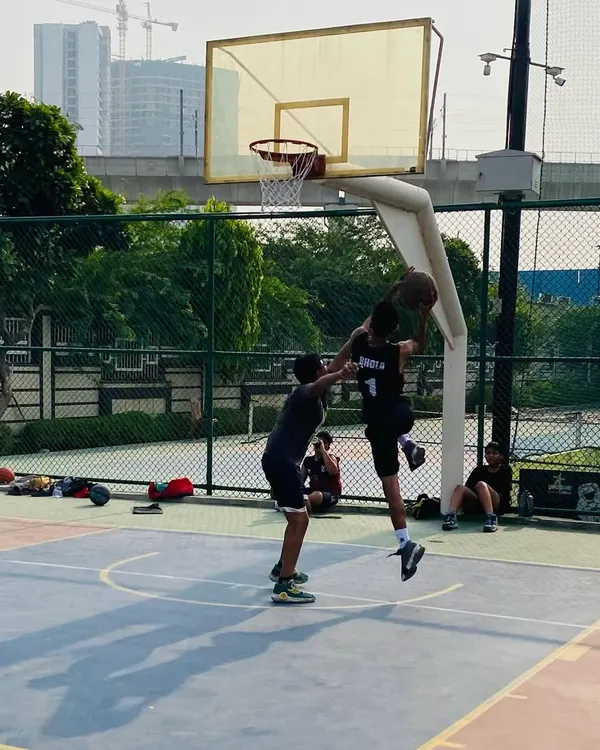 A player executes a jump shot over a defender. We teach players how to create space and get their shot off even when contested.