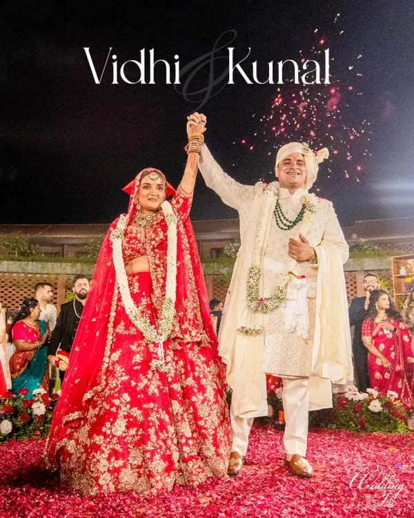 The moment of victory and union. The couple raises their hands in celebration after the Varmala exchange, showered in confetti and love.