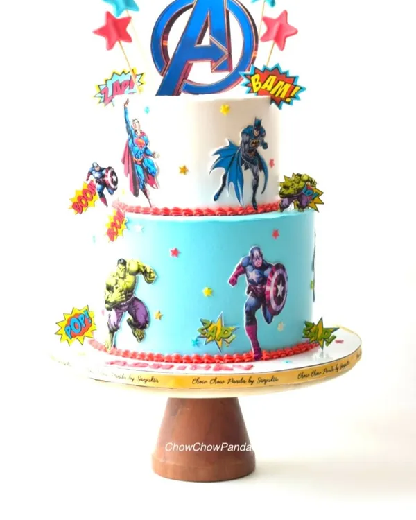 An action-packed two-tier Avengers theme cake. I decorated this Oreo Cream o Cookie cake with edible prints of Hulk, Captain America, Superman, and Batman, complete with fun "BAM!" and "POW!" toppers for a true comic book feel.