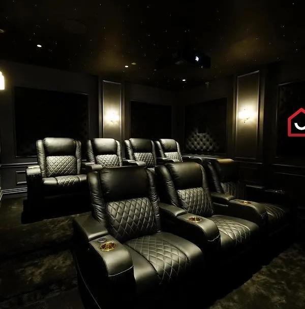 A glimpse into a super-luxury 7.2.4 home cinema in Kanchipuram, featuring Denmark's M&K audio solution. The room is defined by its dark, classic aesthetic with diamond-stitched leather recliners.
