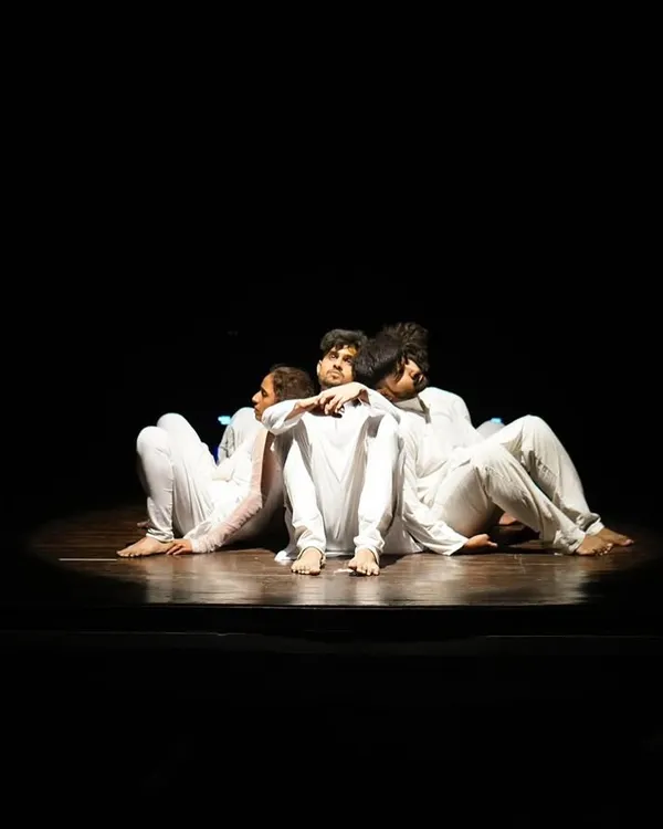 A quiet, powerful moment from our patriotic production, "Inquilab." This image shows our focus on storytelling and emotional expression, where dancers are posed back-to-back under a single spotlight, creating a sense of unity and reflection.