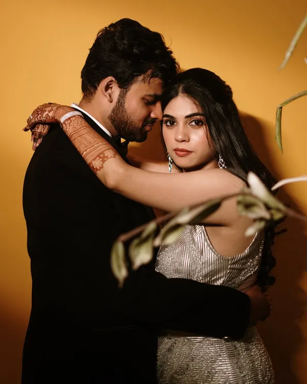 An intimate embrace against a bold yellow backdrop. This shot showcases our use of color and dramatic lighting to create a modern, high-fashion look.
