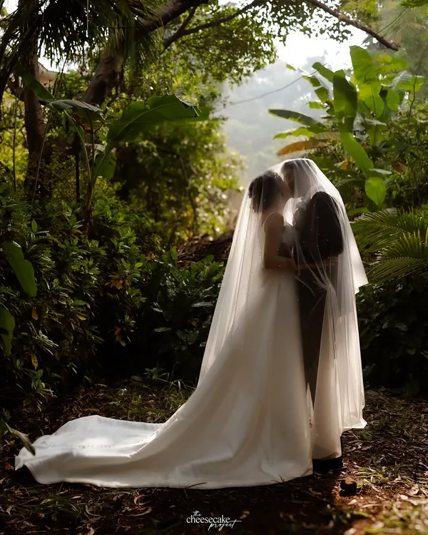 A truly magical portrait, with the couple enveloped in the bride's veil, creating a private, dreamy world of their own.