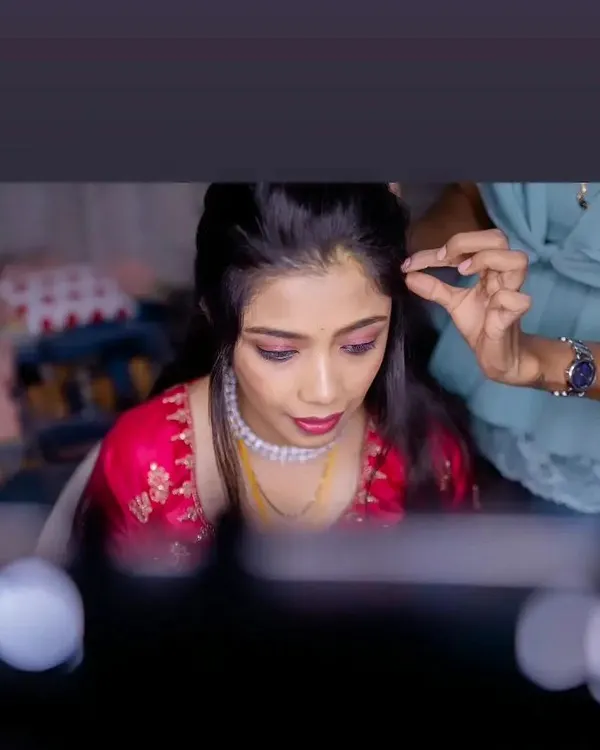A glimpse into my process. Here I am styling the hair for Vasudha's reception look, ensuring every detail is perfect.