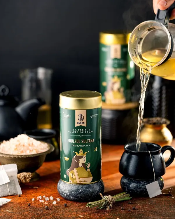 A dynamic pour of green tea into a black mug for Hindraj Tea. The action shot captures the steam and movement, bringing the simple act of making tea to life in a dark and moody setting.