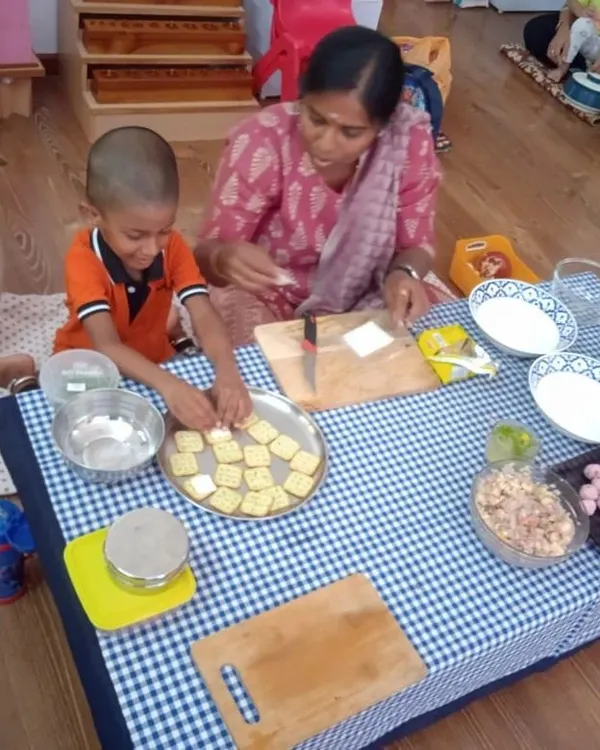 Our parent community is an integral part of our school. Here, a mother and child work together to prepare a snack. These sessions are a wonderful way for parents to get involved and share their own healthy recipes.