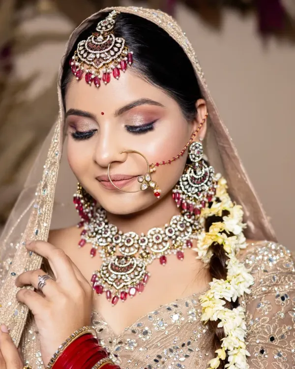 A soft, romantic bridal look with shimmering pink eyeshadow and a classic red bindi. This is a perfect example of the detailed work my students learn to create for their portfolios.