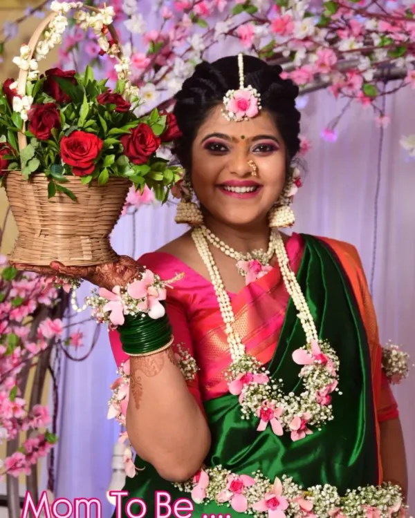 The perfect 'Mom To Be' glow. This beautiful client is wearing a custom set with pink roses and baby's breath, complete with a necklace, maang tikka, and hathphool for her baby shower.