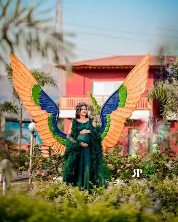 This is one of my absolute favorite pieces for a truly magical maternity photoshoot. The emerald green gown comes with a dramatic feathered overlay and these stunning, colorful angel wings to create a one-of-a-kind look. It’s perfect for mamas who want to feel like a goddess.