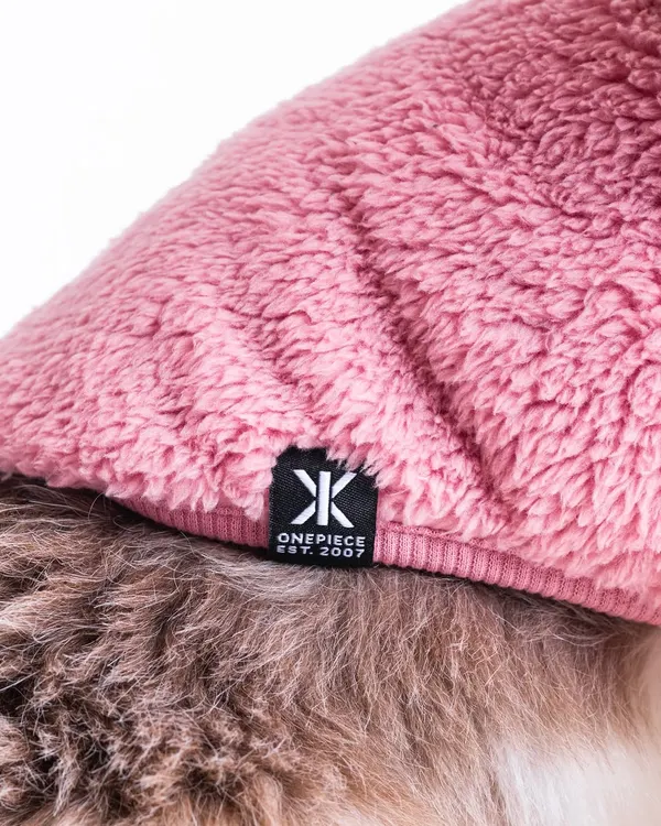 For e-commerce, detail shots are crucial. This close-up of the OnePiece logo on a pet sweater shows the product's quality and branding, helping customers make an informed purchase.
