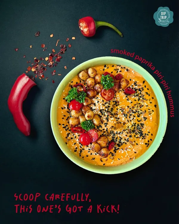 My Smoked Paprika Piri-Piri Hummus, styled for a dramatic effect. This dip has a serious kick, made from red bell peppers smoked to perfection and blended with bold spices for those who love the heat.