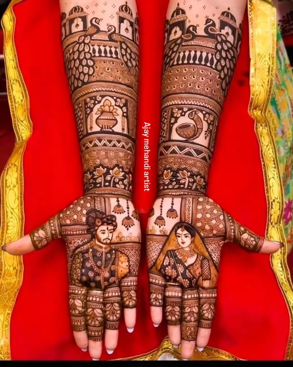 A perfect example of royal bridal portrait mehndi. The groom and bride are detailed on each palm, surrounded by peacock and palace-inspired architecture, giving a majestic feel to your bridal henna.