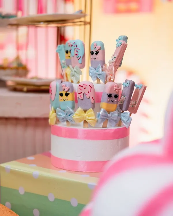 Adorable and delicious. These custom-made cakesicles were designed to match a Candyland theme, complete with pastel colors and tiny bows.