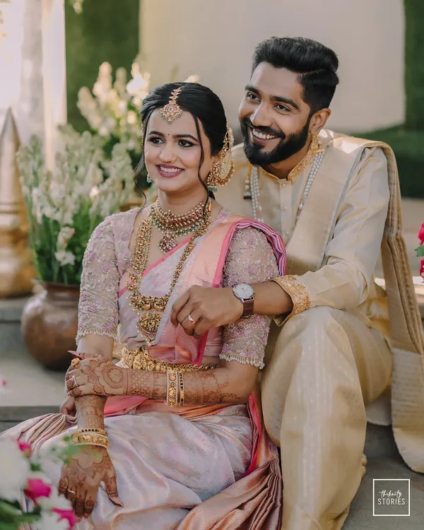 A perfect portrait of two doctors in love, their smiles reflecting a shared journey. This image captures the elegance of their traditional South Indian wedding attire and the easy comfort they find in each other.