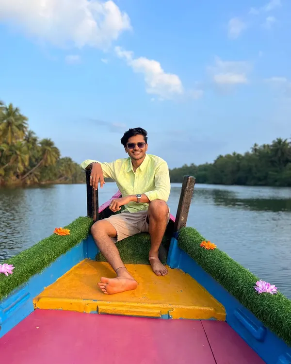 A traveler enjoying the scenic boat ride through the mangrove forest in Honnavara.