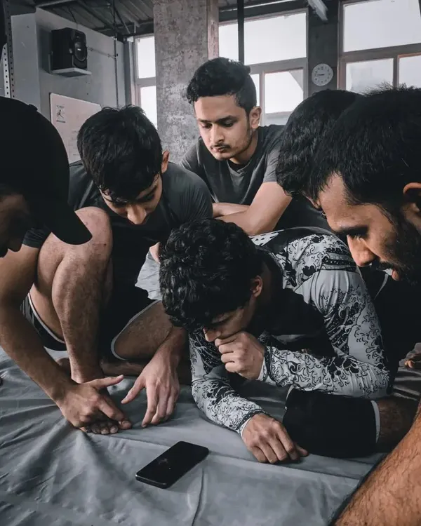 Jiu-Jitsu is a deliberate and detailed study. Here, our students are gathered around a phone, breaking down footage from a roll. This is the intellectual curiosity we foster.