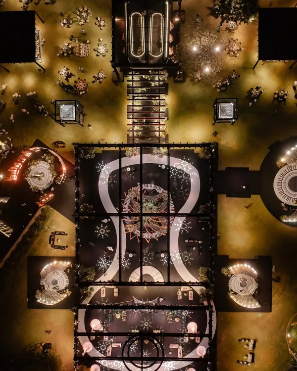 An aerial view of the musical-themed reception, showing the grand layout with the piano-key dance floor as the central element. The entire design was a symphony of patterns and light.