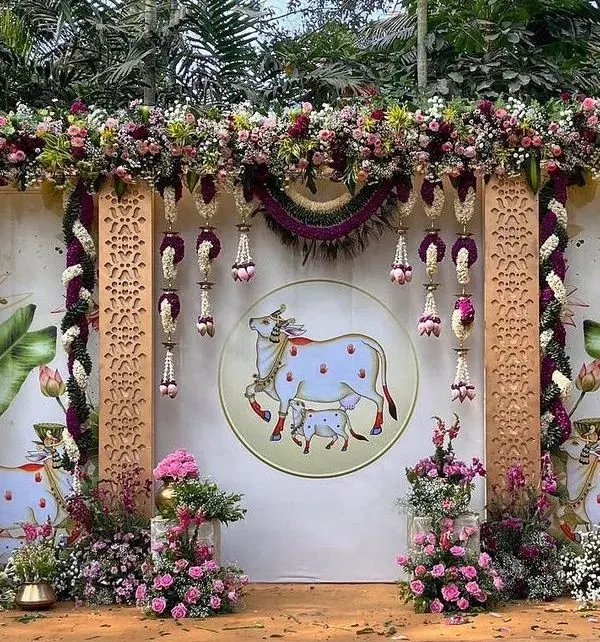 This Pichwai-themed backdrop is one of my absolute favorites to create. The traditional art of the sacred cow and calf, combined with lush florals, brings such a divine and serene feeling to any celebration, especially for a baby shower or housewarming.