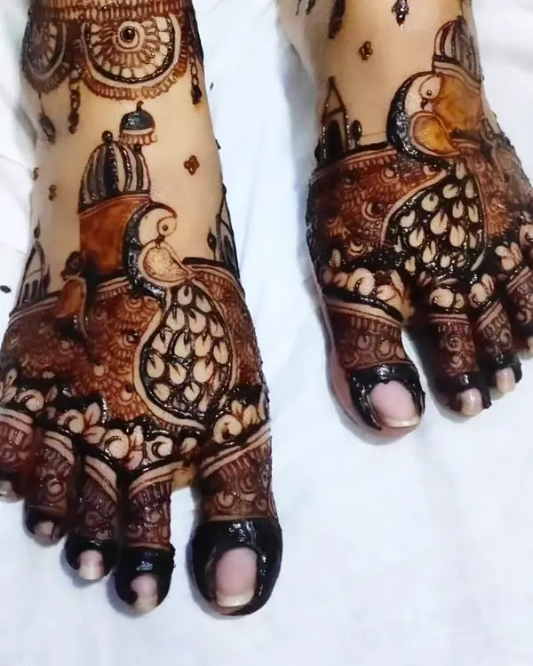 A stunning bridal foot design featuring intricate peacock motifs, a symbol of royalty and grace.