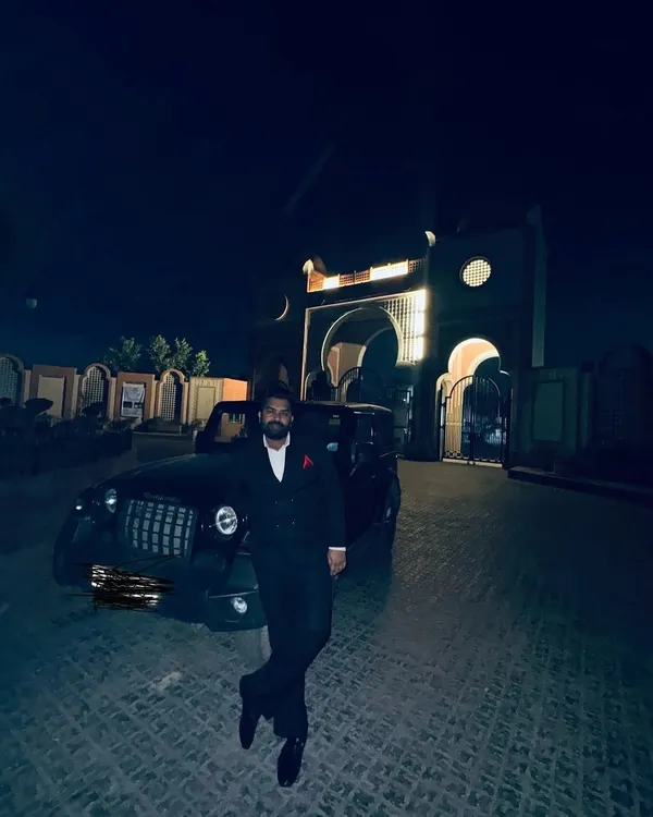 A contemplative moment at night, with my car parked before a grand, arched building. In such moments, I am reminded of Faiz's words that though the night of sorrow is long, it is, after all, just a night.