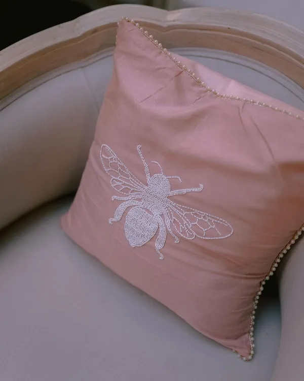 Details make the difference. For one wedding, we created custom upholstery with this beautiful hand-embroidered bee motif, adding a personal and whimsical touch to the decor.