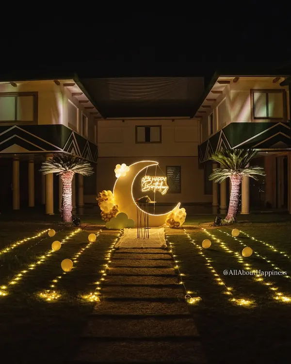 This is what dreams are made of. We created this magical moon-themed birthday surprise in a beautiful outdoor space, complete with a custom moon backdrop, glowing neon sign, and a pathway of lights. It’s perfect for making someone feel truly special under the stars.