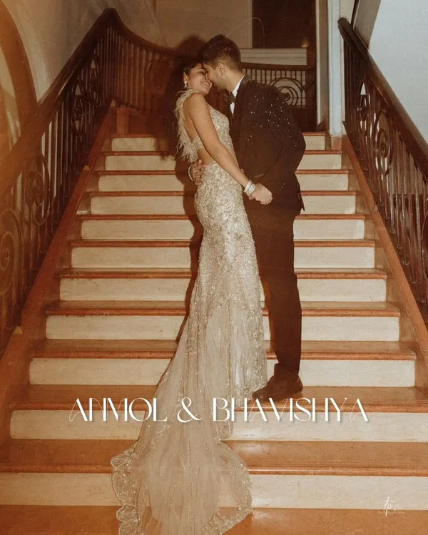 Anmol and Bhavishya's pre-wedding portrait on this grand staircase is a perfect example of editorial elegance. The sweeping train of the gown and the intimate pose create a powerful, romantic statement.