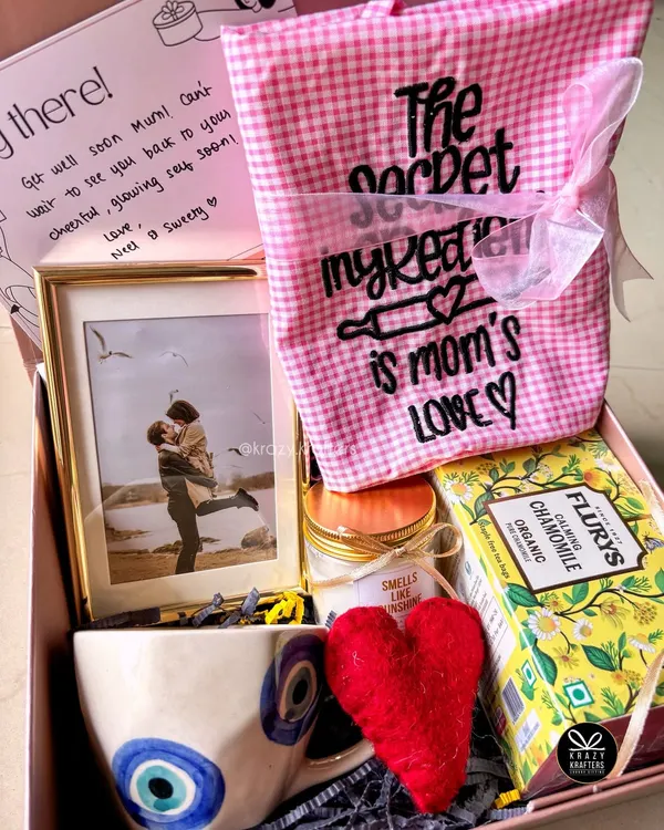 A thoughtful 'Get Well Soon' hamper for a mom, filled with comforting items like chamomile tea, an evil eye mug for good vibes, and a personalized photo frame.
