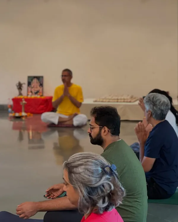 Participants listen with focus during an in person satsang. These sessions are not lectures but shared explorations into topics that matter, guided by the principles of Sivananda philosophy.