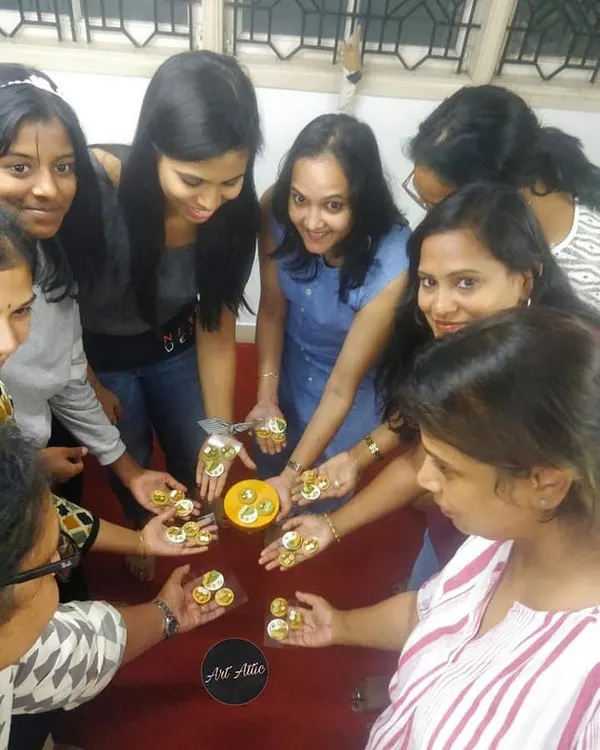 A circle of creativity! Participants in a miniature workshop show off the tiny, detailed pieces they made together.