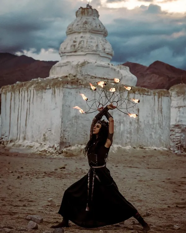 A solo fire artist performs with fire fans against the stark beauty of a remote landscape. Our shows can be adapted for unique outdoor locations, creating powerful, cinematic moments.