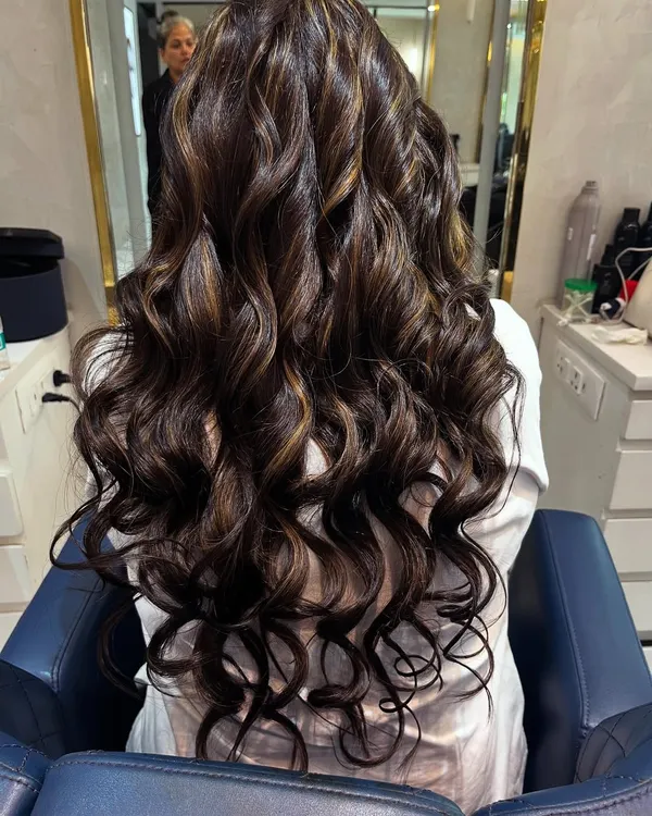 A perfect example of a chocolate brown base with caramel highlights. I styled the hair in deep, glossy curls to show off the dimension and shine of the new colour.