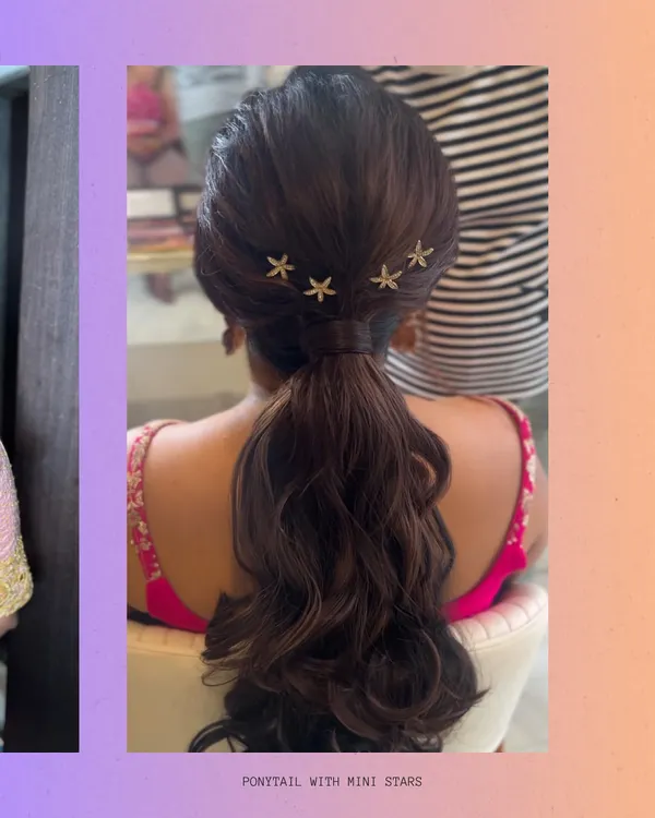 A chic and playful ponytail adorned with mini starfish clips. This style is perfect for a sangeet or cocktail party, offering a modern and fun alternative to traditional updos. The ends are curled for extra bounce and volume.