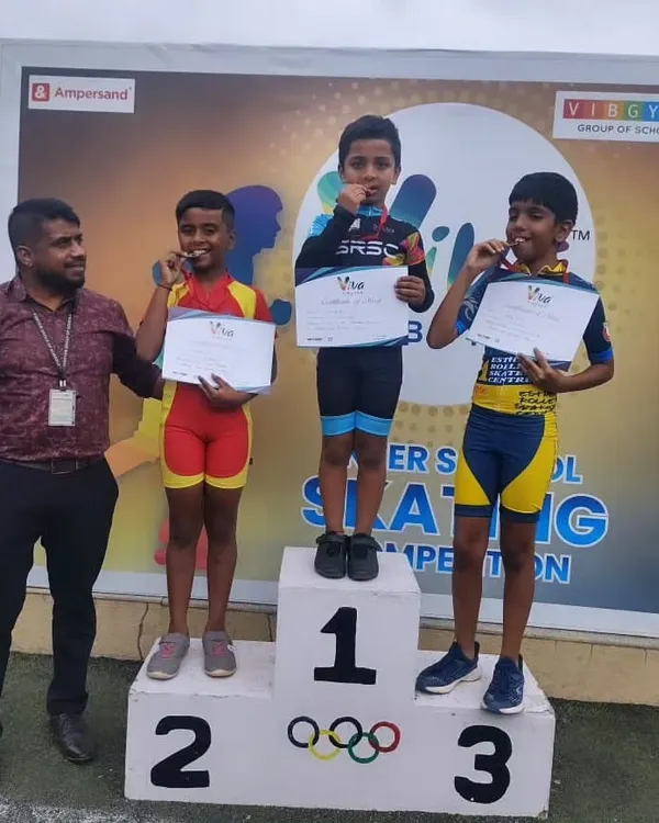 A picture of pure joy and achievement. Our coach stands proudly with our skaters as they dominate the podium at the VIBGYOR Group of Schools inter-school skating competition.