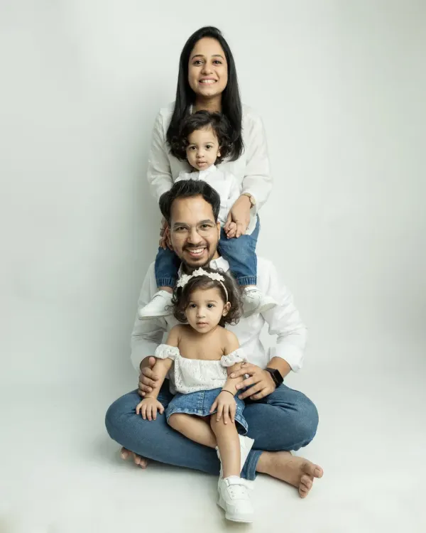 A fun and creative family pose! This stacked portrait is a playful way to capture the whole family together.