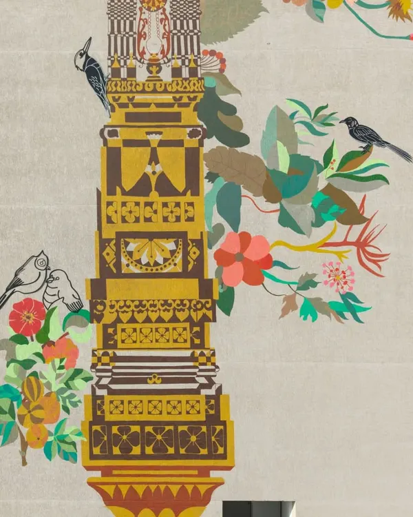 A close-up of the 'Tower of Harmony' mural, showcasing the intricate details inspired by local textiles, temple carvings, and architectural ornamentation of Gujarat. Native birds and flora are woven into the design, symbolizing the connection between nature and civilization.