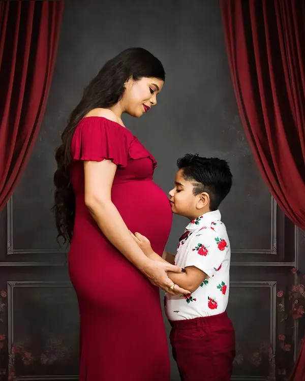 Welcoming a new baby is a family affair. I love capturing moments like this, where an older sibling connects with the baby bump. It’s a beautiful way to document your family's growing love story.
