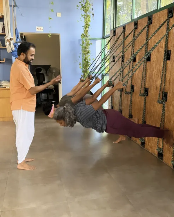 This is a moment from my Yoga Kurunta (Rope Yoga) workshop. Here, I am guiding students as they use the ropes for support, allowing them to achieve deeper alignment and experience poses in a new way. This practice is excellent for building strength and confidence.