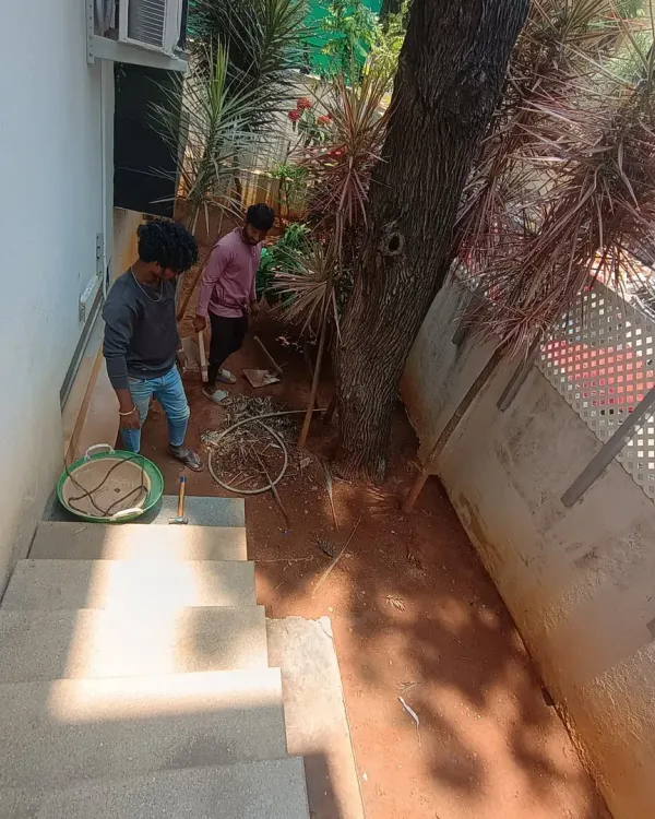 Before the transformation: a cluttered and unused space at the bottom of a staircase. This is the starting point for a new pathway and garden.