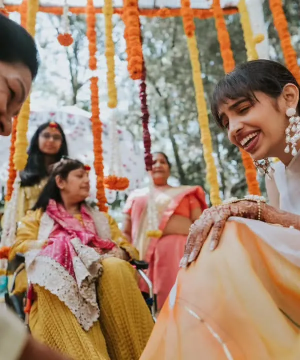 A beautiful, candid moment of laughter between the bride and her family during the Haldi ceremony. These are the memories we love to create the backdrop for.