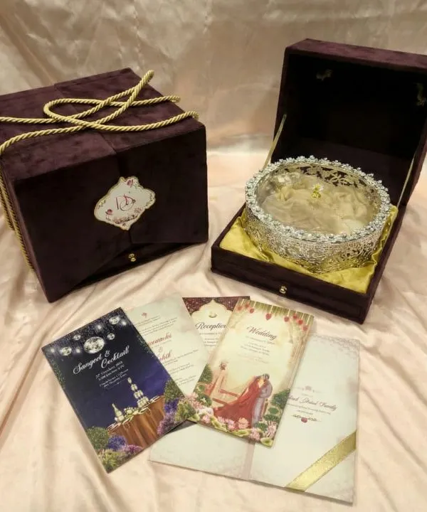This bespoke wedding invitation, housed in a deep purple velvet box, is designed to be a treasured keepsake. The set includes beautifully illustrated cards for each ceremony, creating a complete and elegant story for your special day.