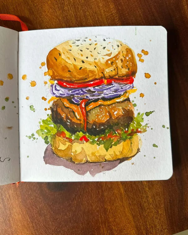 A detailed watercolor illustration of a delicious burger from my sketchbook. I focused on capturing the layers, from the toasted sesame seed bun to the fresh toppings, making it look as tasty on paper as it is in real life.