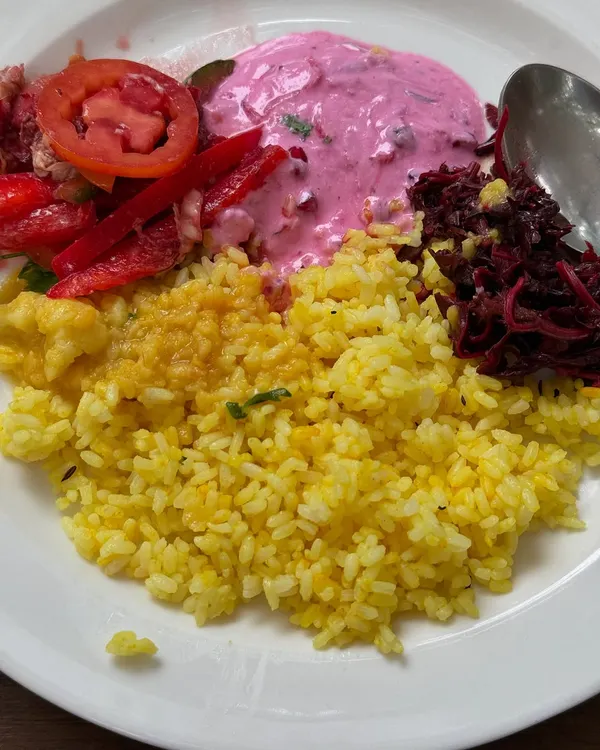 A plate full of color and life. This is what nourishment looks like at my retreats: vibrant beetroot raita, fresh salads, and flavorful rice, all designed to be as delicious as it is healthy.