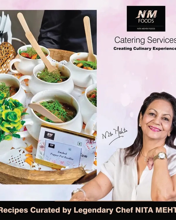 Every menu we create is backed by the expertise of the legendary Chef Nita Mehta. This image shows her alongside our Smoked Pepper Pot Noodles, a dish curated from one of her signature recipes.