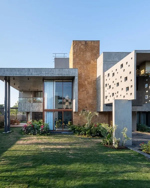 This is what we mean by bold residential architecture. We used raw concrete and natural stone to create strong geometric forms, balanced with large glass panels that flood the interior with light and connect it to the lush green surroundings.