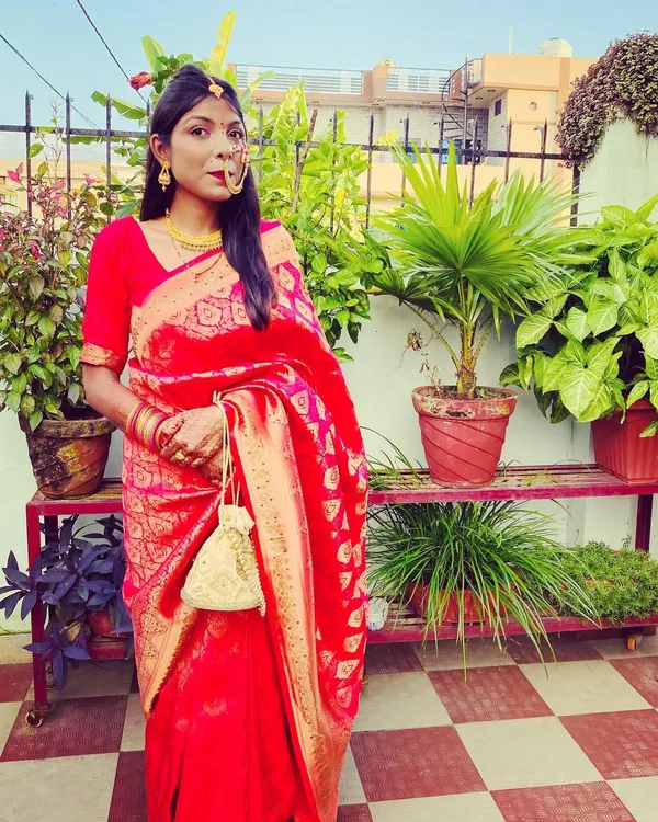 This is my take on a traditional 'Pahadi Bahu' or bride look. The classic red saree paired with a gold nath is a timeless combination. I can help you create authentic cultural looks that honor your heritage.